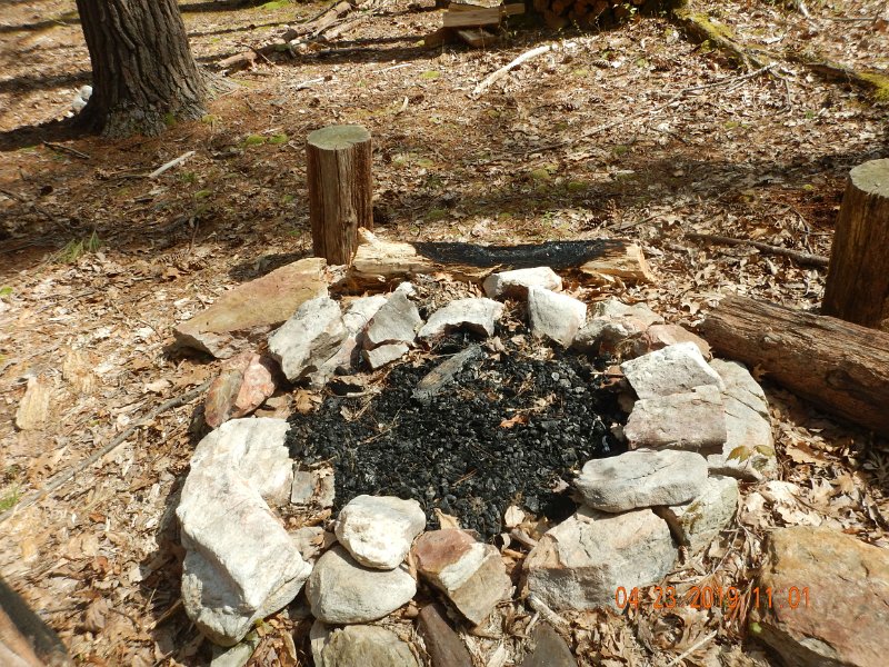 $FowlersHollowStatePark134$.jpg - Burnt logs outside of the fire ring is asking for problems. People wonder how forest fires happen.  Well, it's just like this.
