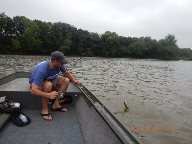 DSCN2316.jpg -                                The water was high and muddy but we still got a few bass.  Gary landing one.